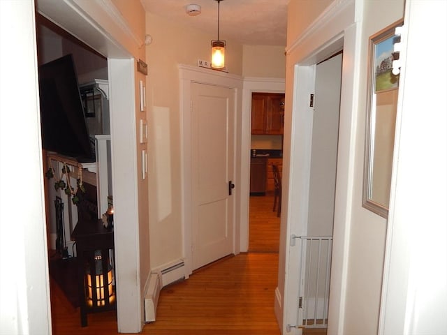 hallway featuring baseboard heating and light wood finished floors