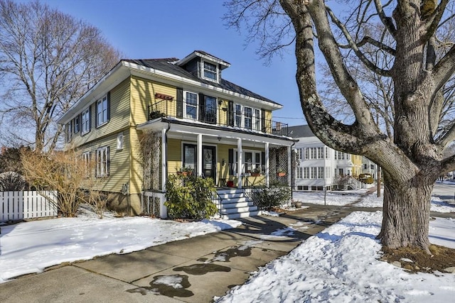 view of front facade featuring a balcony and covered porch