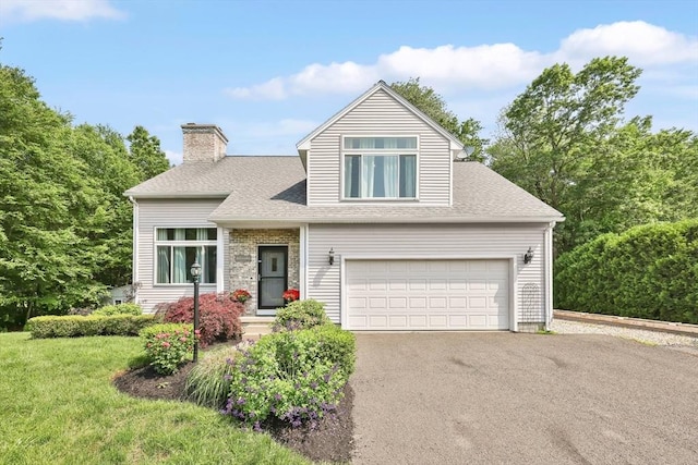 24 Azalea Way, Belchertown, MA 01007 - traditional-style home with asphalt driveway, a chimney, a shingled roof, an attached garage, and a front yard
