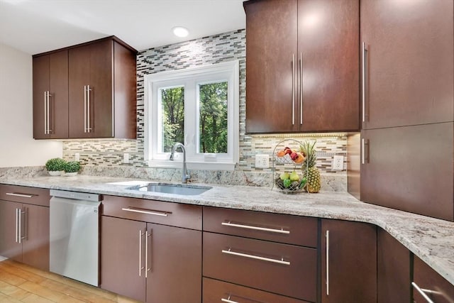 24 Azalea Way, Belchertown, MA 01007 - kitchen with stainless steel dishwasher, tasteful backsplash, light stone counters, and dark brown cabinetry
