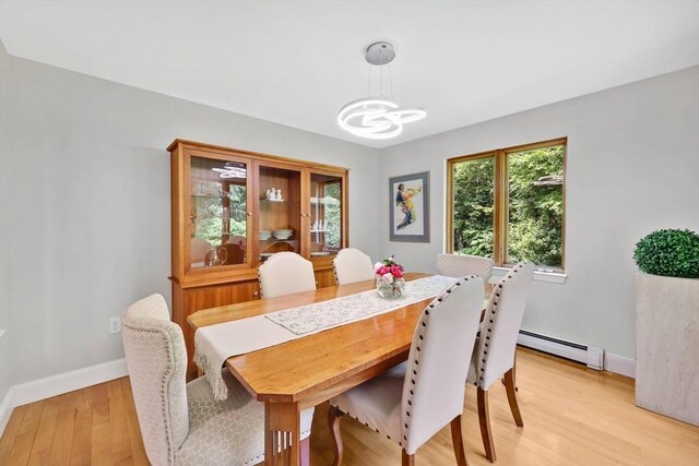 24 Azalea Way, Belchertown, MA 01007 - dining space featuring a baseboard radiator, a chandelier, and light wood-type flooring