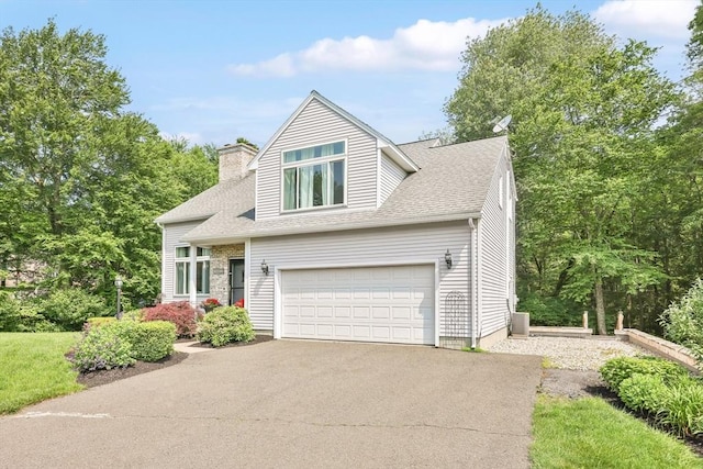 24 Azalea Way, Belchertown, MA 01007 - view of front facade with asphalt driveway, a chimney, a garage, and a shingled roof