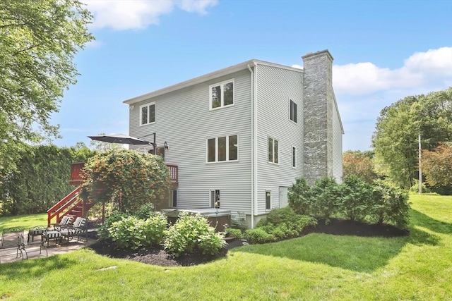 24 Azalea Way, Belchertown, MA 01007 - back of property with a chimney, a lawn, stairs, and a patio