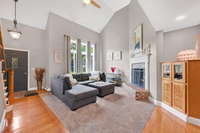 24 Azalea Way, Belchertown, MA 01007 - living room featuring wood-type flooring, a fireplace, high vaulted ceiling, ceiling fan, and a baseboard heating unit