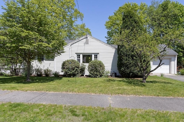 view of home's exterior with a yard, driveway, and a garage