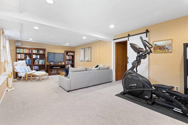workout room featuring carpet, recessed lighting, and a barn door