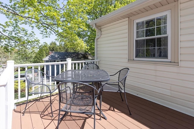 deck with outdoor dining area