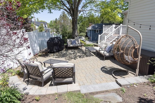 view of patio with an outdoor living space, fence, grilling area, an outbuilding, and a storage shed