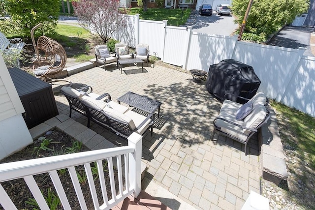 view of patio featuring outdoor lounge area, fence, and a grill