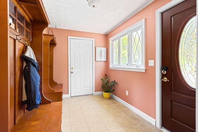 foyer with light tile patterned floors and baseboards