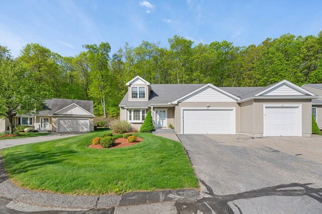 view of front of property with a front yard and asphalt driveway