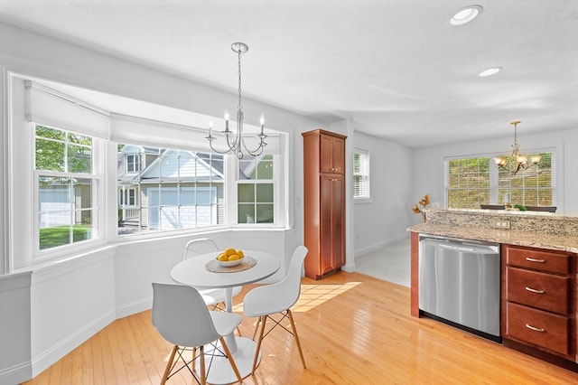 dining space featuring a chandelier, baseboards, light wood-type flooring, and recessed lighting