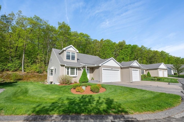 view of front of property with an attached garage, a front yard, and asphalt driveway