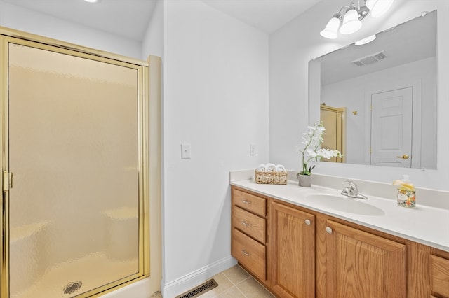 full bathroom featuring tile patterned floors, a shower stall, vanity, and baseboards