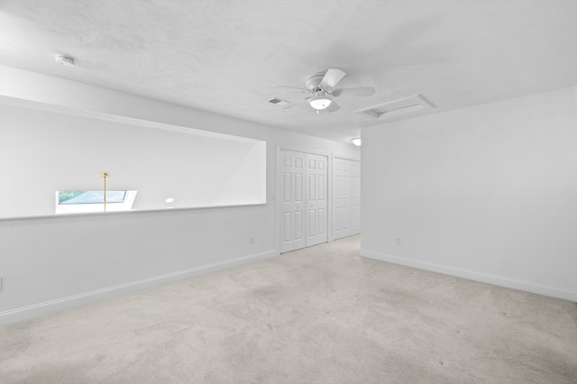 unfurnished room featuring attic access, carpet, baseboards, and a smoke detector
