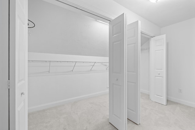 walk in closet with carpet floors