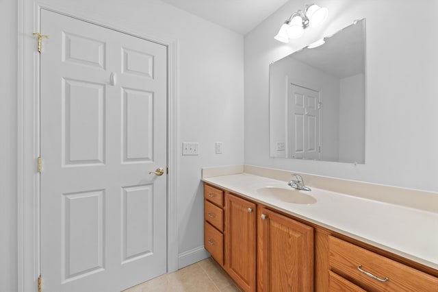 bathroom with tile patterned flooring, vanity, and baseboards