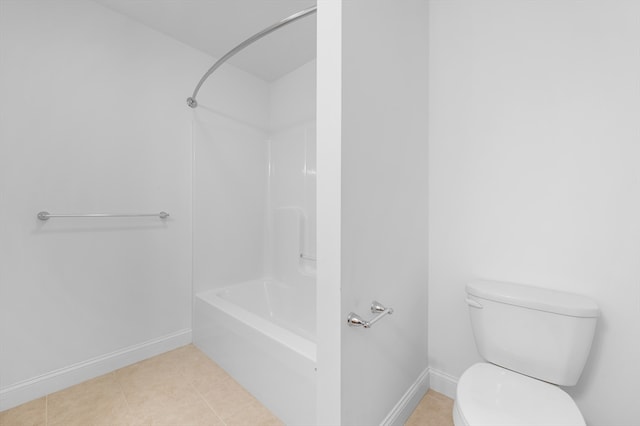 bathroom featuring toilet, baseboards, tile patterned flooring, and shower / bath combination