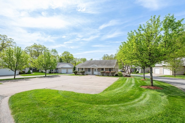 ranch-style house with a front yard and uncovered parking