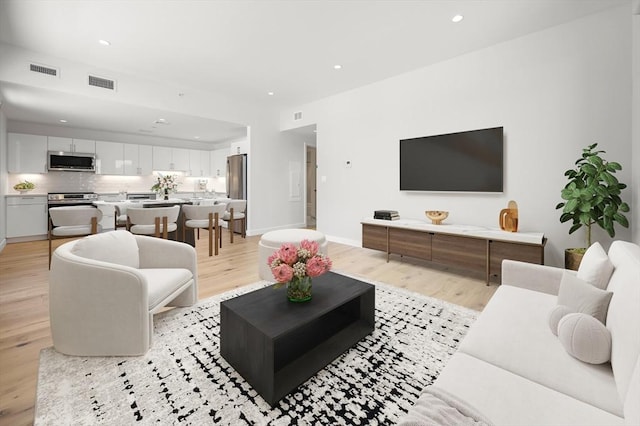 2149 Washington St Unit 601, Boston, MA 02119 - living area featuring light wood-style flooring, recessed lighting, and baseboards