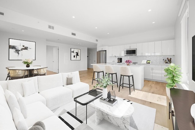 2149 Washington St Unit 601, Boston, MA 02119 - living area featuring light wood finished floors and recessed lighting