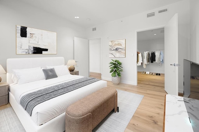 2149 Washington St Unit 601, Boston, MA 02119 - bedroom featuring wood finished floors, a spacious closet, recessed lighting, a closet, and baseboards