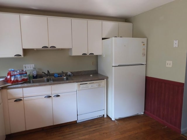12C Oliver St Unit 12C, Haverhill, MA 01832 - kitchen featuring white appliances, a sink, white cabinetry, dark wood-type flooring, and a wainscoted wall