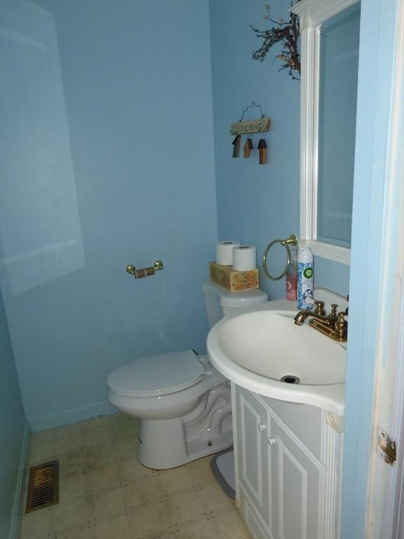 12C Oliver St Unit 12C, Haverhill, MA 01832 - half bath featuring vanity, toilet, and tile patterned floors