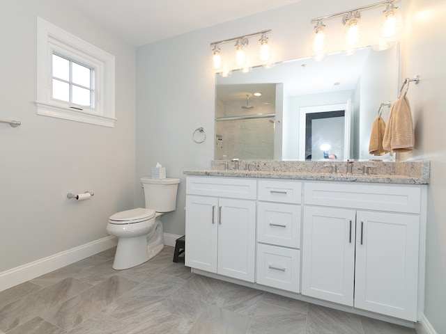 bathroom featuring walk in shower, vanity, and toilet