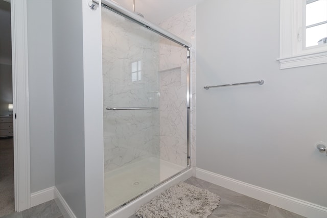 bathroom with a shower with door