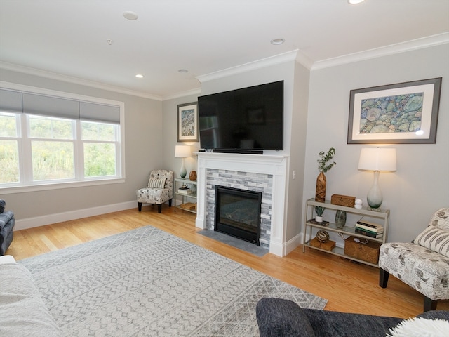 living room with ornamental molding, hardwood / wood-style flooring, and a fireplace