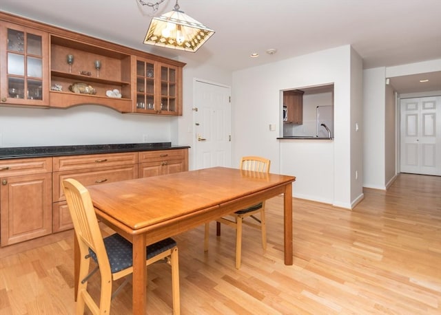 173 Oak Unit 208W, Newton, MA 02464 - dining area with light wood-style flooring and baseboards