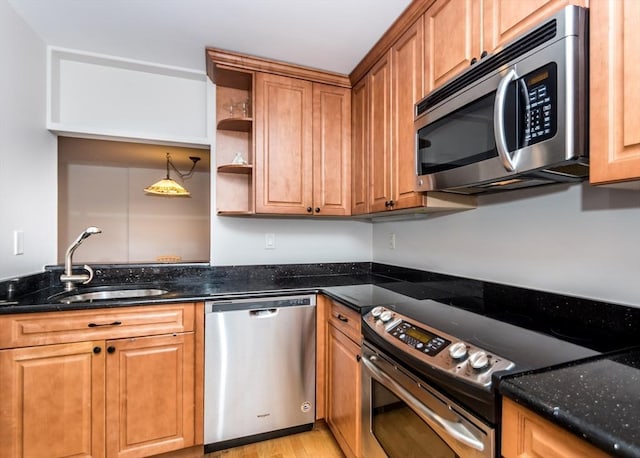 173 Oak Unit 208W, Newton, MA 02464 - kitchen with appliances with stainless steel finishes, light wood-style floors, dark stone counters, and open shelves