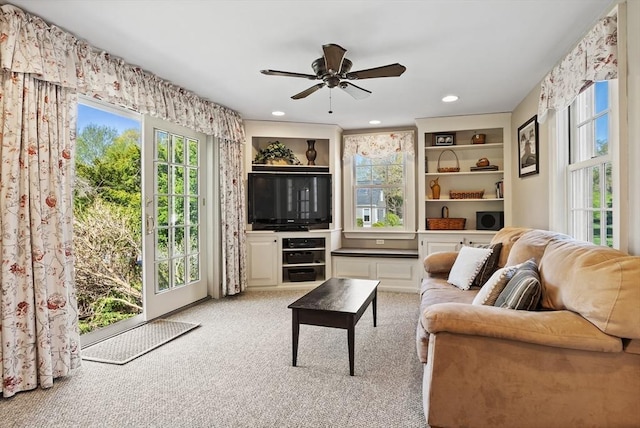living room featuring ceiling fan and light carpet