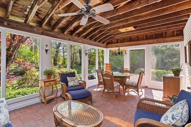 sunroom featuring brick flooring, french doors, and a chandelier