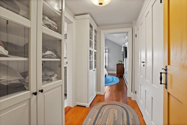 hallway with light wood-style flooring and baseboards