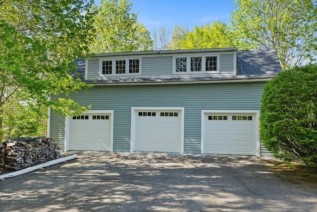 garage with asphalt driveway
