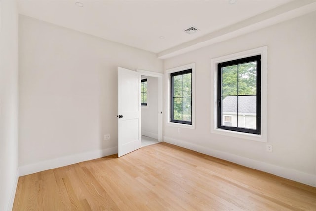 empty room with light hardwood / wood-style floors