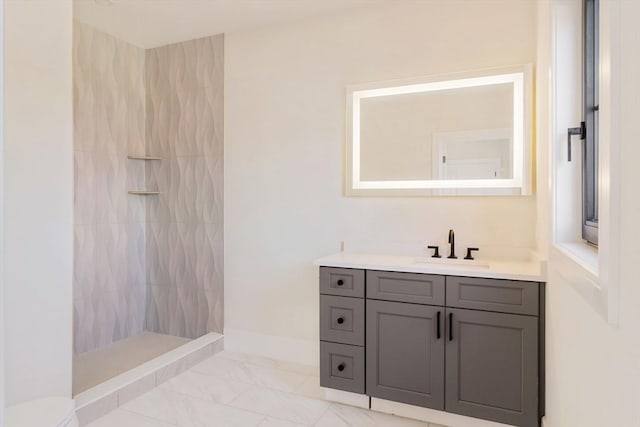 bathroom with vanity and tiled shower