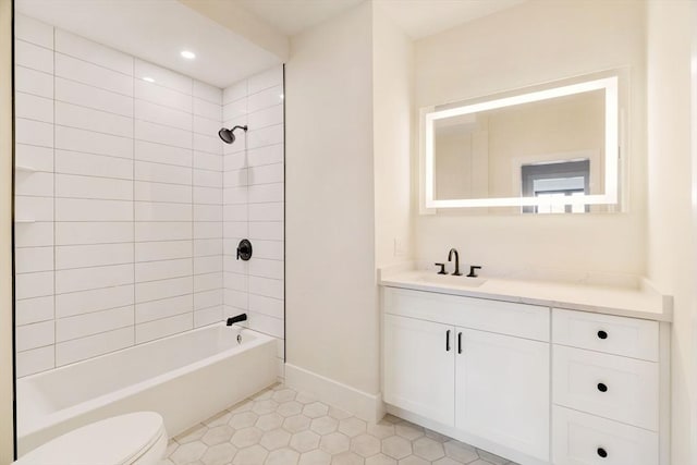 full bathroom featuring vanity, tiled shower / bath combo, tile patterned floors, and toilet