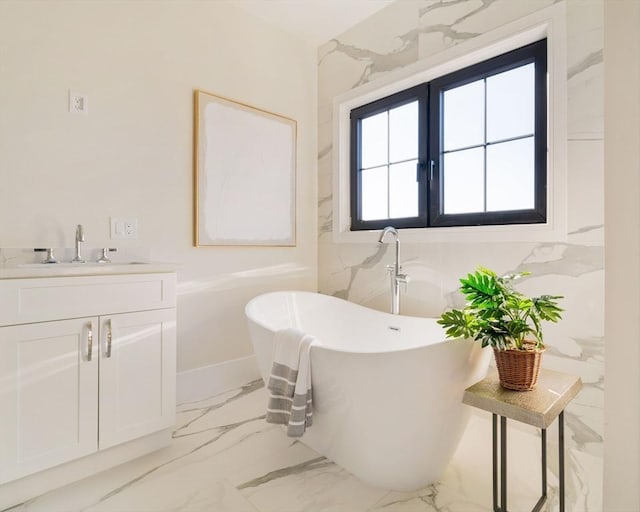 bathroom with a tub and vanity