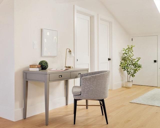 home office featuring light hardwood / wood-style flooring and lofted ceiling