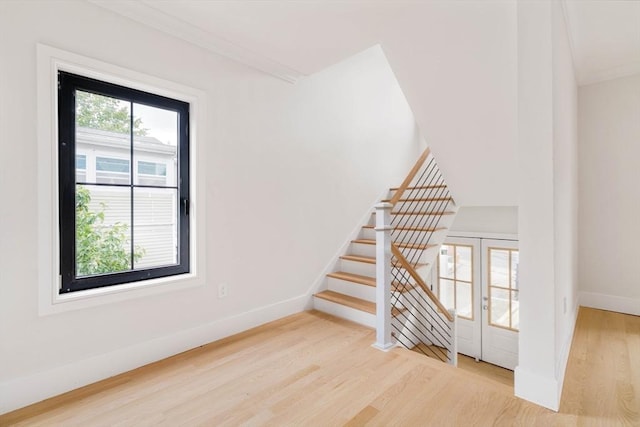 interior space with crown molding, plenty of natural light, and hardwood / wood-style floors