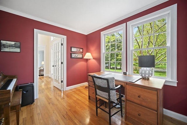 office area featuring light wood-style floors, baseboards, and crown molding