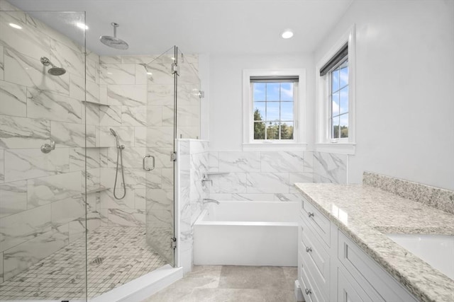 bathroom with a garden tub, a marble finish shower, vanity, and recessed lighting