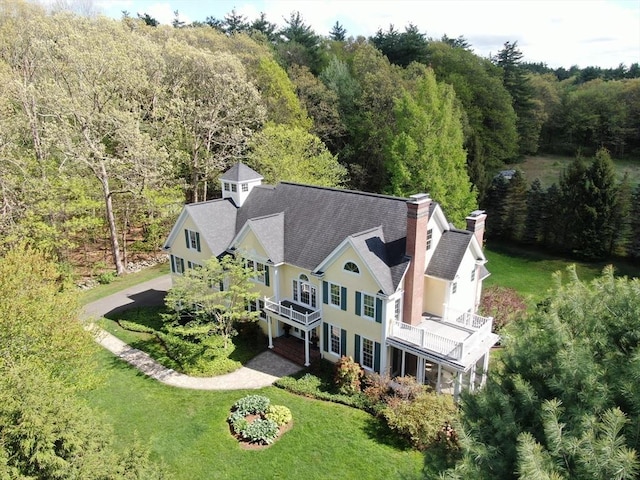 view of subject property with a heavily wooded area