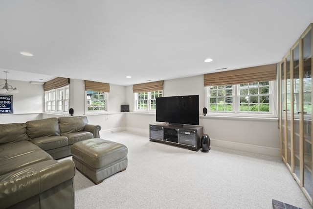 living area featuring plenty of natural light, carpet floors, baseboards, and recessed lighting