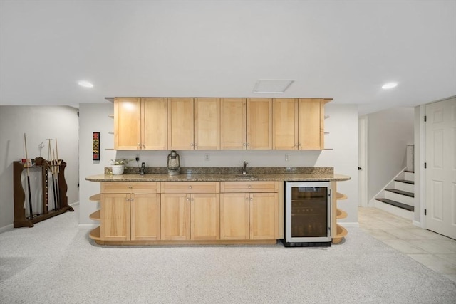 kitchen featuring open shelves, wine cooler, a sink, recessed lighting, and stone countertops