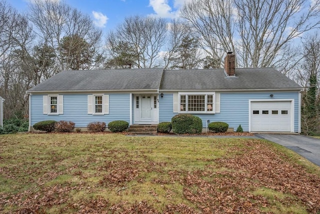 ranch-style home with a front yard and a garage