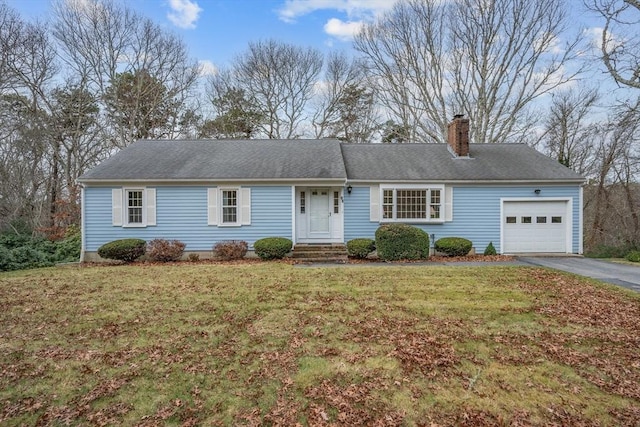 ranch-style home with a front lawn and a garage